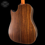 Back view of a wooden acoustic guitar with 'Tone Shop' branding.