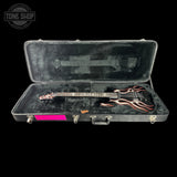 Guitar with flame design in a hard case, brand 'Tone Shop' visible