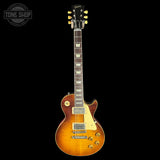 Gibson electric guitar with a sunburst finish on a black background