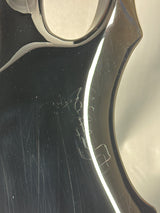Close-up of a metallic object with visible scratches and reflections
