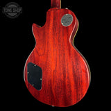 Red electric guitar body with 'Tone Shop' logo in the corner