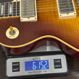 Guitar on a digital scale displaying weight