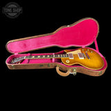Gibson Les Paul guitar in a pink-lined case with 'Tone Shop' logo.