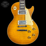 Electric guitar with a sunburst finish on a black background, featuring the Tone Shop logo.