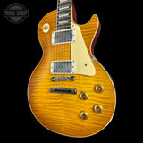 Electric guitar with a sunburst finish on a black background, featuring the Tone Shop logo.