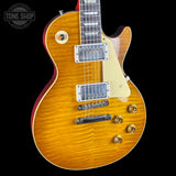 Electric guitar with a sunburst finish on a black background, featuring the Tone Shop logo.