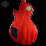 Red Gibson electric guitar body with brand logo on a black background