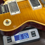 Guitar on a digital scale displaying weight