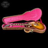 Gibson Les Paul guitar in a pink-lined case with 'Tone Shop' logo.