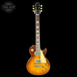 Electric guitar with a sunburst finish on a black background, featuring the Gibson logo.