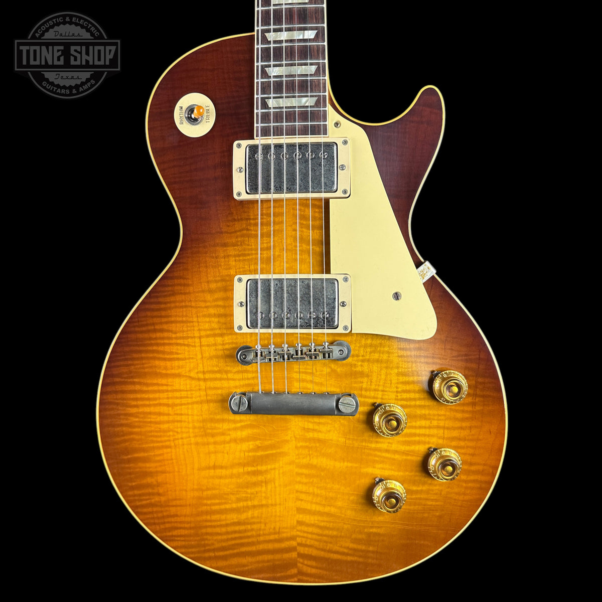 Electric guitar with a sunburst finish on a black background, featuring the Tone Shop logo.