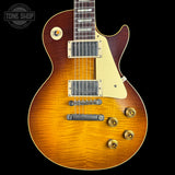 Electric guitar with a sunburst finish on a black background, featuring the Tone Shop logo.