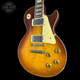 Gibson Les Paul guitar with a sunburst finish on a black background, featuring the Tone Shop logo.