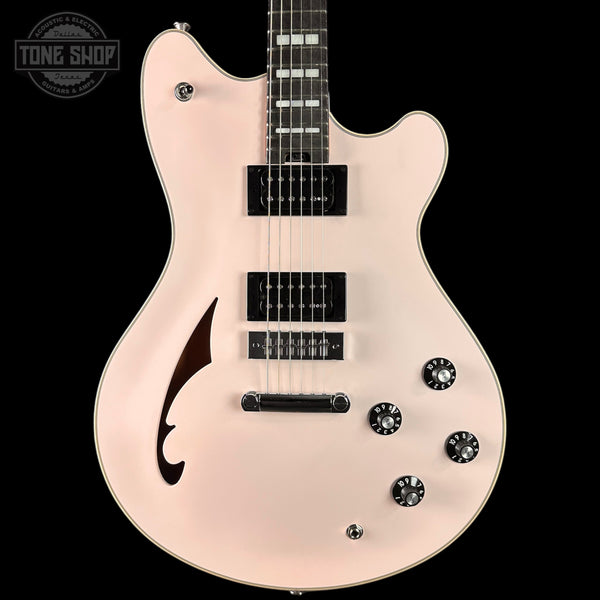 Electric guitar with a pearl finish on a black background, featuring the Tone Shop logo.