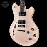 Electric guitar with a satin finish on a black background, featuring the Tone Shop logo.