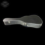 A black hard guitar case with silver metal latches and trim, shown from a side profile against a solid black background. A circular Tone Shop logo is visible in the top-left corner.