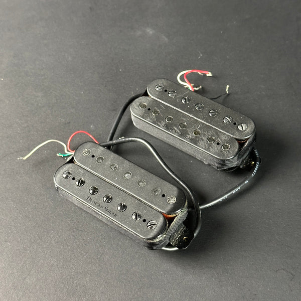 Two guitar pickups on a gray background