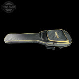 Black guitar case with gold trim on a black background, featuring the Tone Shop logo.