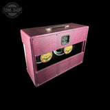 A pink textured guitar amplifier cabinet with a top handle, dual visible speakers, and a Tone Shop logo on the upper left, shown against a solid black background.