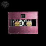 A dual speaker amplifier cabinet with a textured magenta-pink crocodile-embossed finish, featuring two large silver speakers with gold and black centers, shown against a solid black background.
