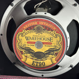 A close-up of a vintage-style speaker driver with a circular label reading Warehouse ET90, featuring ornate red, gold, and black graphics on a white speaker rim.
