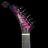 Close-up of the headstock of a Fender Stratocaster electric guitar with a purple and black flame maple finish, shown against a solid black background.