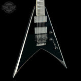 Black electric guitar with a unique design on a black background, featuring the 'Tone Shop' logo.