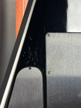 Close-up of a metallic surface with a rectangular plate and circular component.