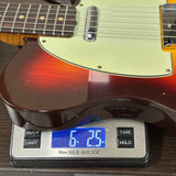 Electric guitar on a digital scale displaying weight