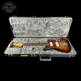 Electric guitar in a hard-shell case with 'Tone Shop' logo.