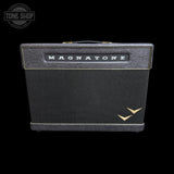 A vintage-style Magnatone guitar amplifier head against a solid black background, featuring a black textured grille, a black top panel with gold trim and the white 'MAGNATONE' logo, and a gold bird logo in the lower right corner.