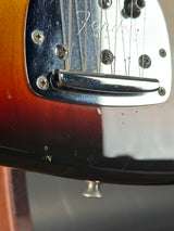 Close-up of a guitar's bridge and headstock