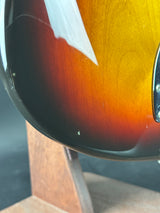 Close-up of a guitar with a sunburst finish on a wooden surface