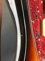 Close-up of a guitar's body with a red and black pattern