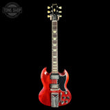 Red electric guitar with a black background, featuring the Gibson logo.