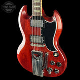 Red electric guitar with a black background, featuring the 'Tone Shop' logo.