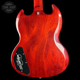 Red electric guitar body with 'Tone Shop' logo in the corner