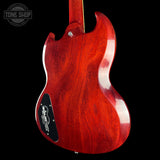 Red electric guitar body with 'Tone Shop' logo in the corner