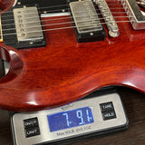 Guitar on a digital scale displaying weight