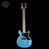 Blue electric guitar on a black background with 'Tone Shop' logo.