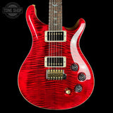 A red electric guitar with a flamed maple top, dual humbucker pickups, and a dark fretboard, shown against a black background with a Tone Shop watermark in the top left corner.