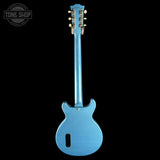 Blue electric guitar on a black background with 'Tone Shop' logo.