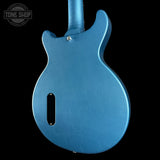 Blue electric guitar body on a black background with 'Tone Shop' logo.