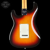 Fender electric guitar with a sunburst finish on a black background