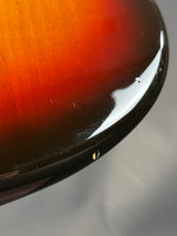 Close-up of a reflective surface with a gradient from red to black.