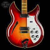 Electric guitar with a red and white design on a black background, featuring the Tone Shop logo.