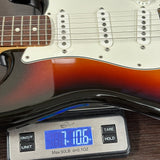 Electric guitar on a digital scale displaying weight
