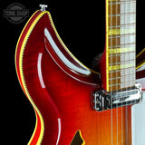 Close-up of a red electric guitar with a black background