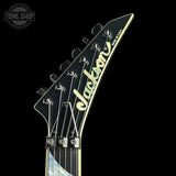 Guitar headstock with 'Jackson' branding on a black background