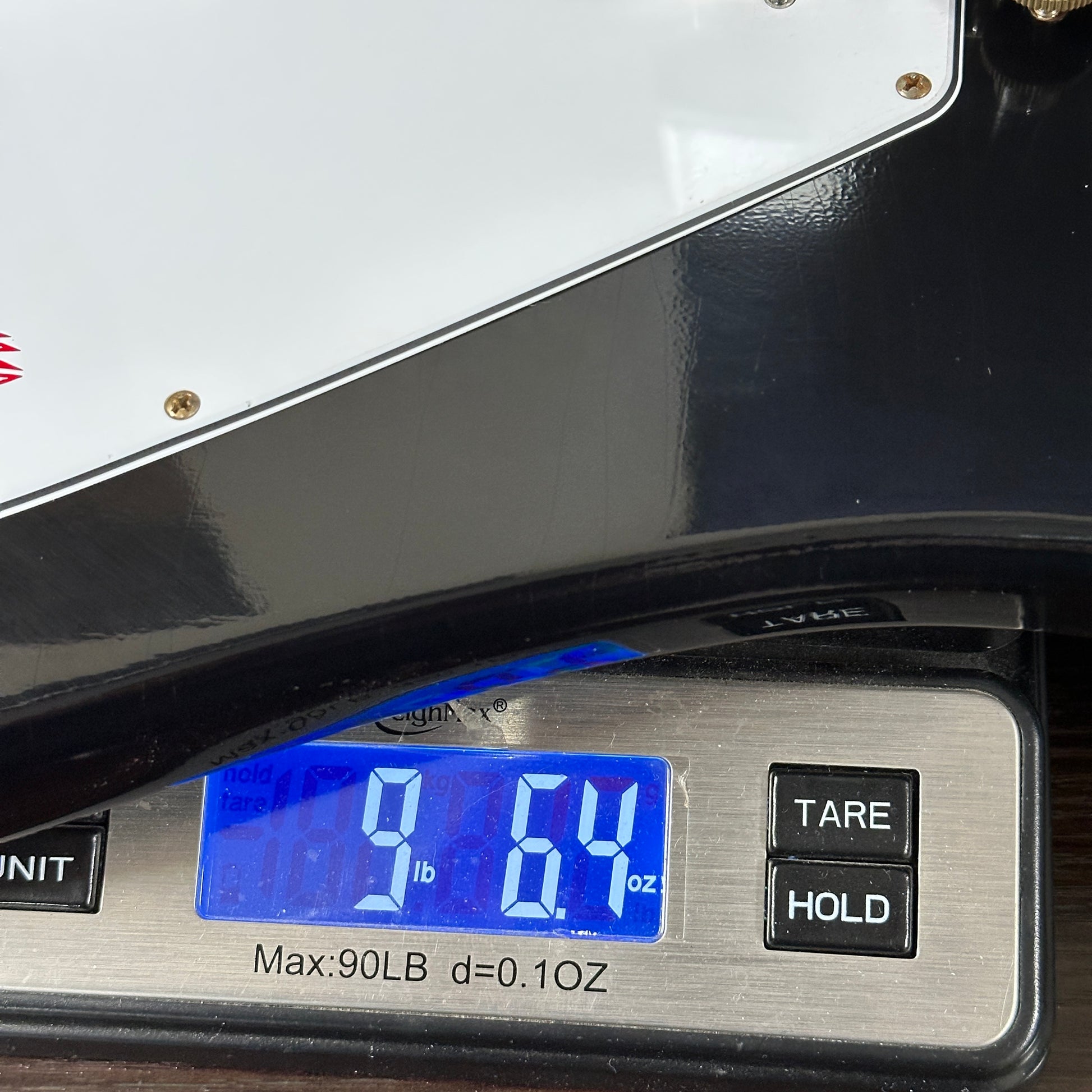 Digital scale displaying weight with buttons labeled 'TARE' and 'HOLD'.
